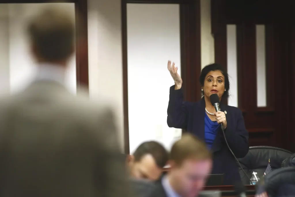 At right, Rep. Daisy Morales (D-Orlando) asks a question of Rep. Jay Trumbull (R-Panama City), left, about his bill titled CS/SB 2-D: Property Insurance, in the Florida House of Representatives Wednesday, May 25, 2022, at the Capitol in Tallahassee, Fla. (AP Photo/Phil Sears)